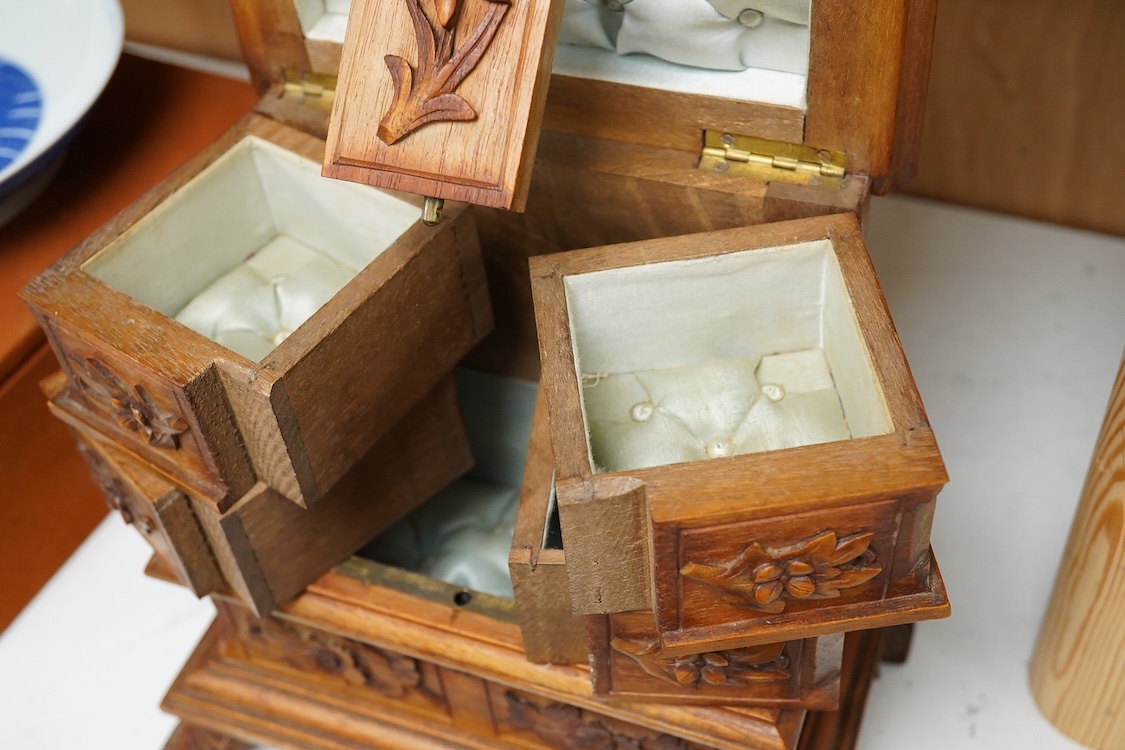 A 20th century black forest carved wood jewellery box, surmounted with two deer, 28cm high